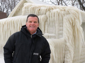 John Kucko stands by a frozen building in Webster near Lake Ontario. Courtesy of John Kucko.